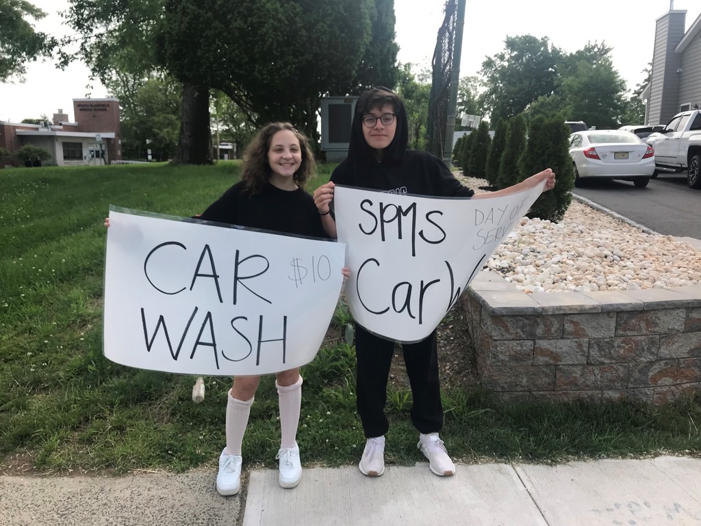 Middle School Students participating in the Day of Service by providing a car wash.  All proceeds will go to fighting childhood cancer. 
