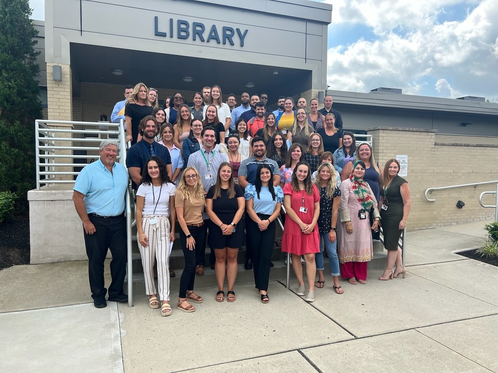 New faculty and staff pose outside of the South Plainfield Memorial Library