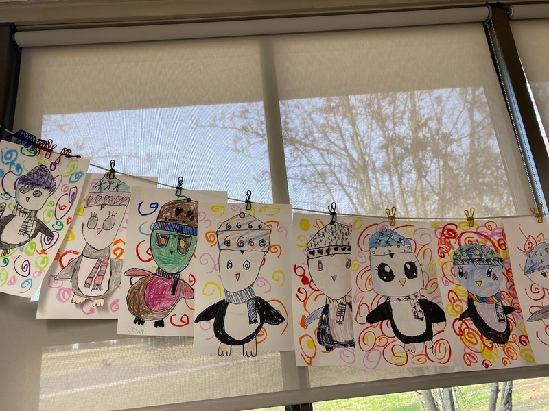 a third image of penguin artwork hanging in the classroom